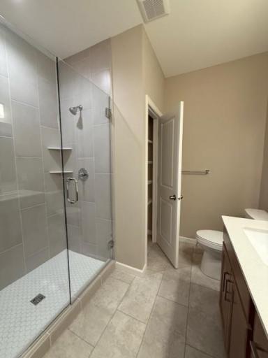 Elegant tilework and modern fixtures elevate the walk-in shower, offering a sleek, spa-inspired design that feels both timeless and on-trend.