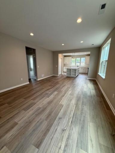 Open floorplan creates a seamless connection between the family room, kitchen, and dining areas—ideal for entertaining and family togetherness.