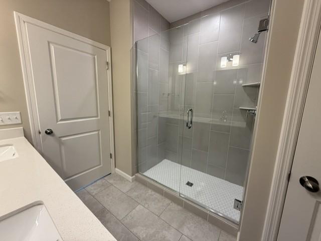 Elegant tilework and modern fixtures elevate the walk-in shower, offering a sleek, spa-inspired design that feels both timeless and on-trend.