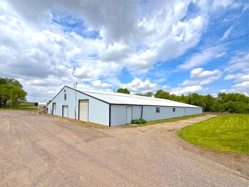 This large, metal-sided building offers multiple wide entry bays for easy access with trailers and equipment, along with ample interior space for stalls, storage, or a riding area.