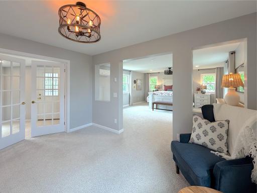 Large windows bring in natural light and offer pleasant views, making it a perfect spot for reading or enjoying a morning coffee.