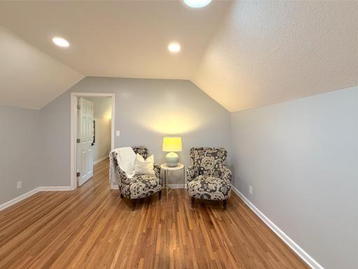 The bright upper-level landing provides a comfortable sitting area, this flexible space is ideal for a reading nook, quiet retreat.