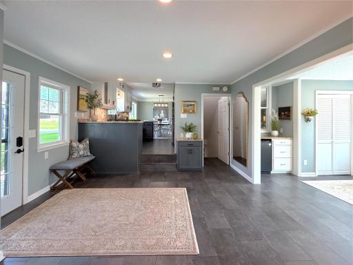 The open layout provides easy flow throughout the home, with a few steps leading up to the kitchen, sun room and family room.