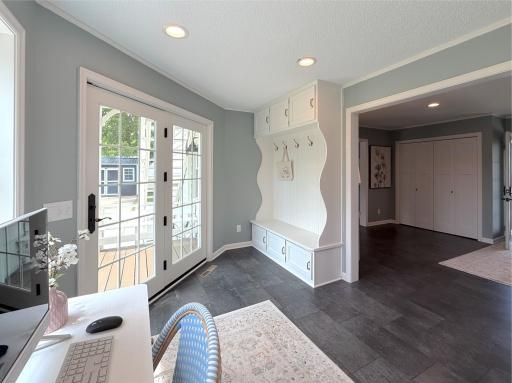 The room is finished with a built-in locker and bench area, creating an ideal drop zone for coats, bags, and everyday essentials.