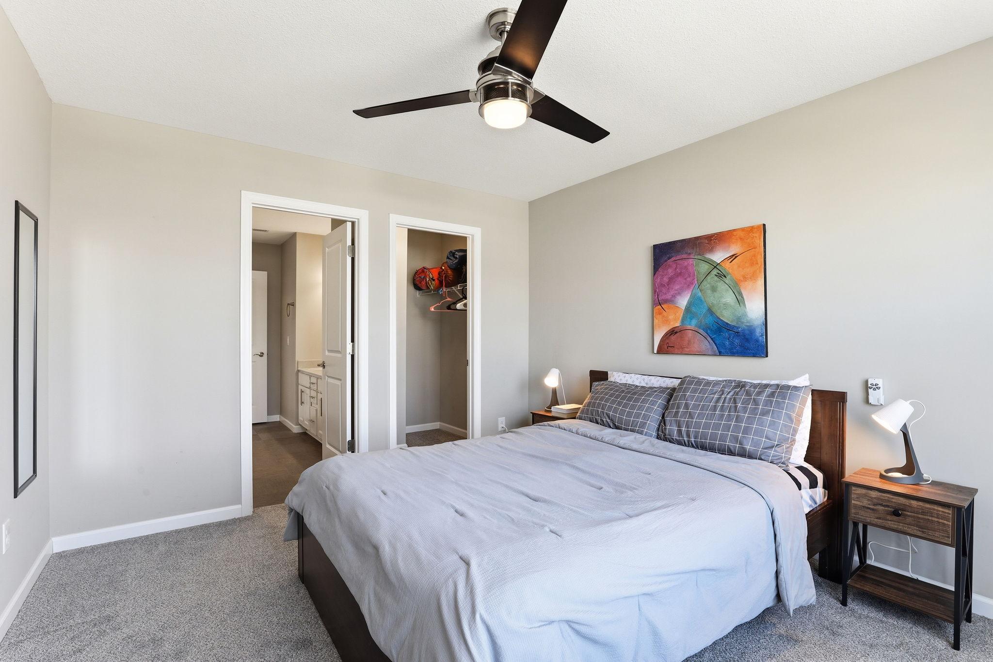 Side-by-side closet and bathroom access doors flank the fourth bedroom, maximizing its utility. Clean walls and soft carpet give this room quiet versatility for any household configuration.