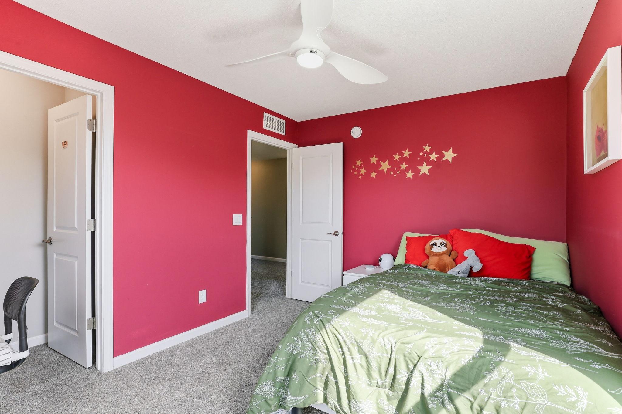A second angle of this upper-level bedroom reveals the dedicated closet access, providing the room with the privacy and functionality you need.