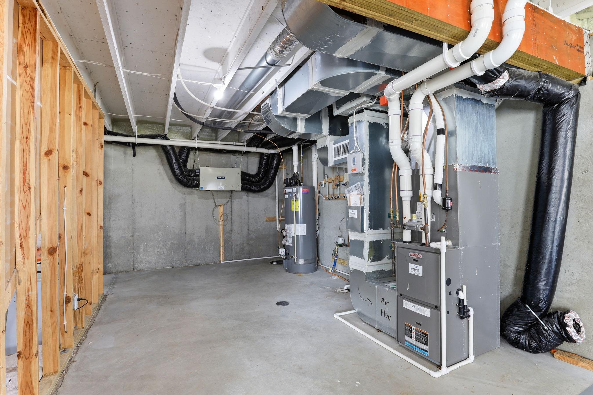 The mechanical room houses the 9-year-old dual forced air systems, gas water heater, and active radon mitigation equipment.