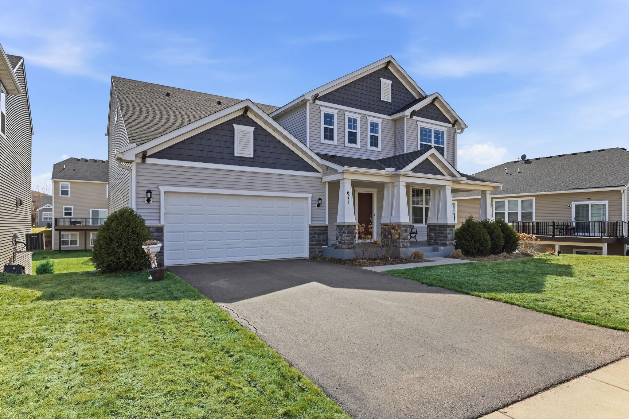 A wide asphalt driveway, 9-year-old roof and siding, and a classic craftsman roofline give this 2016-built home timeless appeal. The attached 3-car tandem garage anchors a polished street presence.