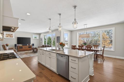 A large center island with breakfast seating, elegant quartz surfaces, and a closet pantry enhance both everyday living and entertaining.