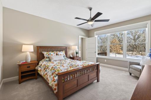 Privately positioned, the primary suite offers a peaceful retreat with plush carpeting, a spacious walk-in closet with built-ins, and a spa-inspired ensuite.