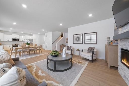 (Photo of a decorated model, actual finishes will vary.) An electric fireplace for makes for cozy evenings in the beautiful Great Room.