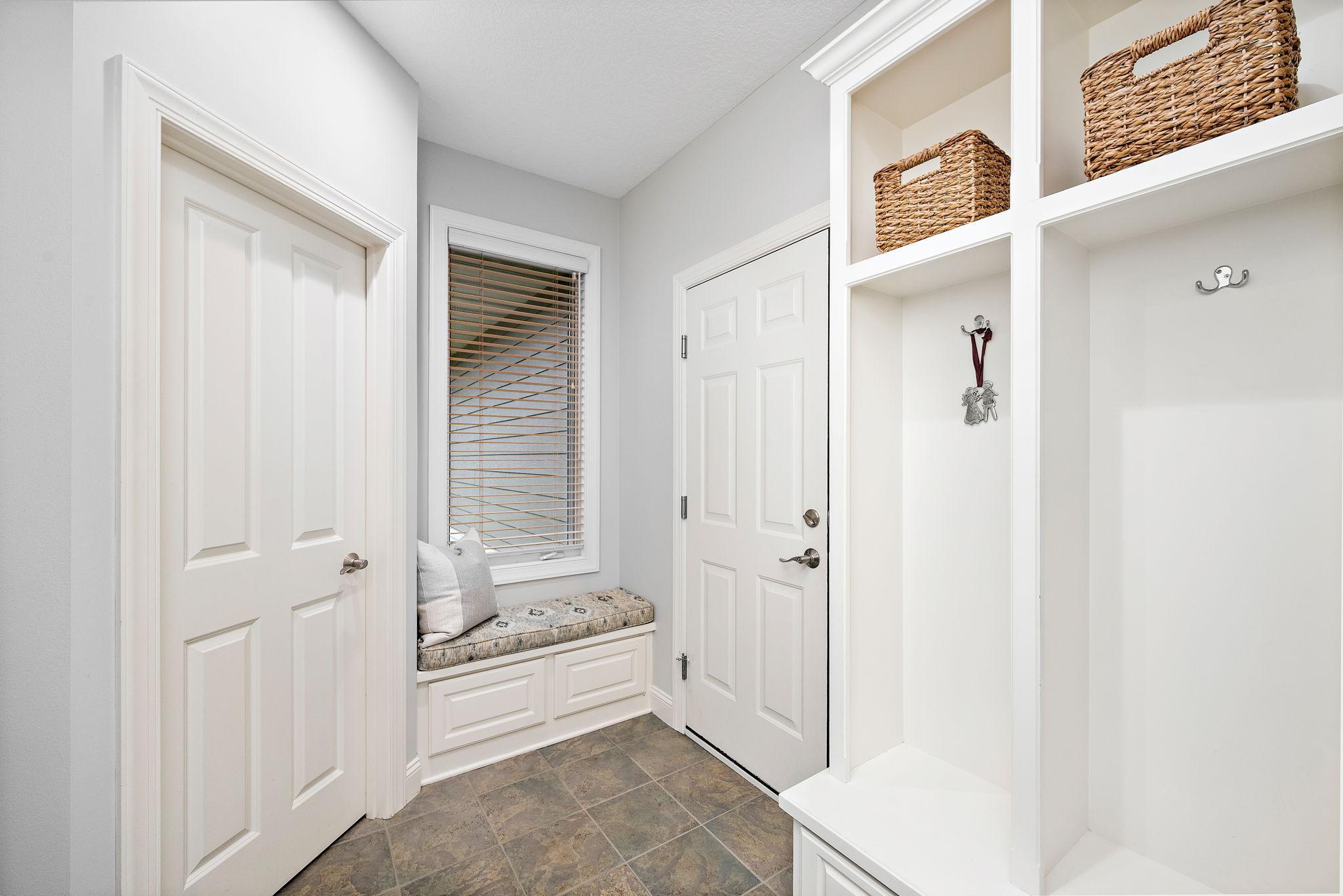 Back hallway, drop zone. Spacious coat closet and boot bench