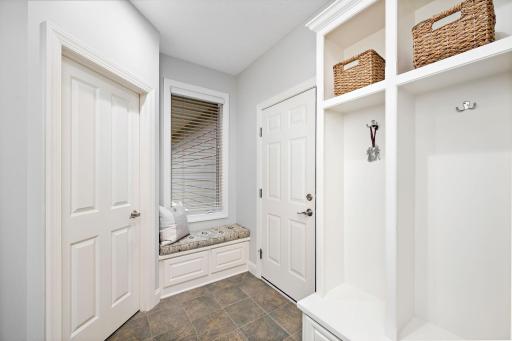 Back hallway, drop zone. Spacious coat closet and boot bench