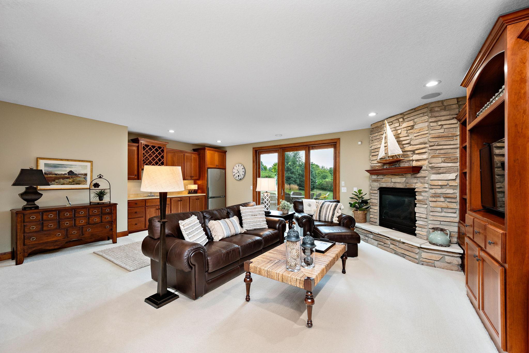 Lower level family room, complete with wet bar, gas fireplace, and builtins