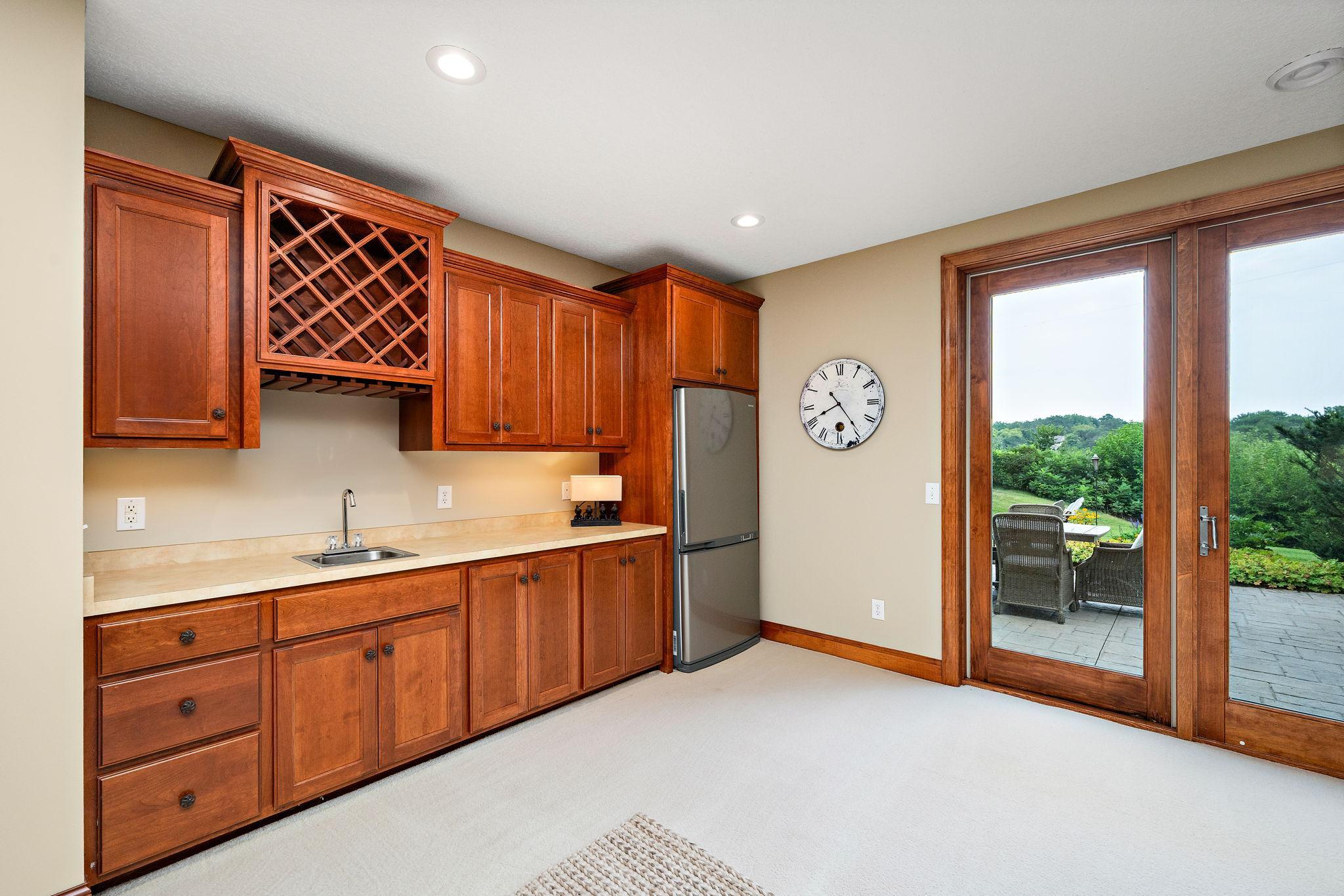 convenient wet bar and walkout to lower level patio and gardens