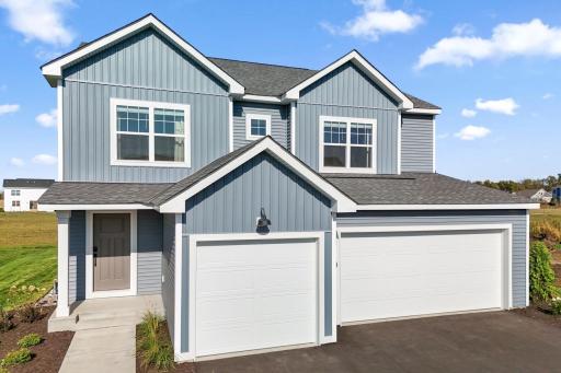 The exterior showcases contrast between lap siding and board and batten, with coastal style lighting. Photo of model home, colors and finishes may vary.