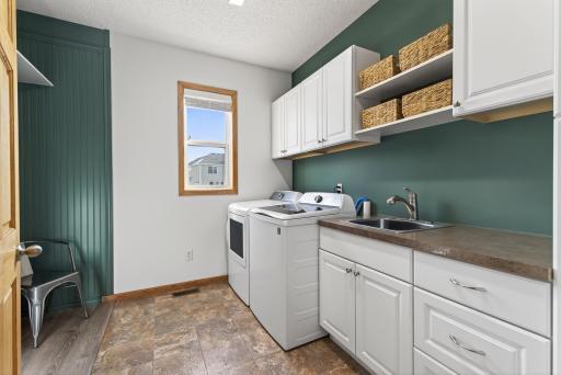 Easy to stay organized with Main Floor Laundry add so much storage!