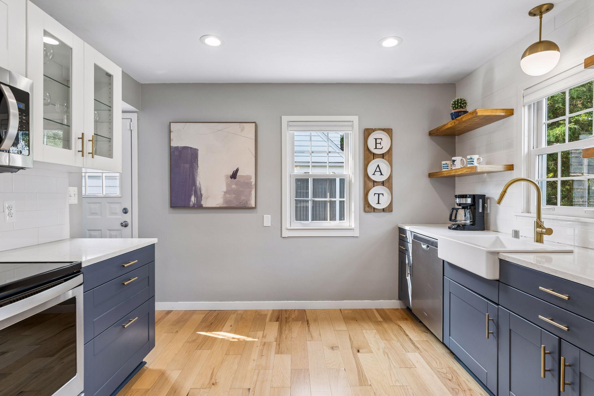 Nicely updated with modern open shelving, lighting, and farmhouse sink.