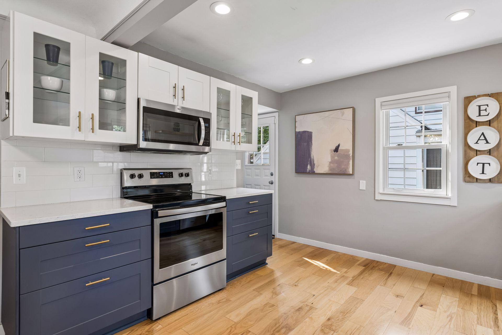 Enameled cabinets with updated gold hardware.