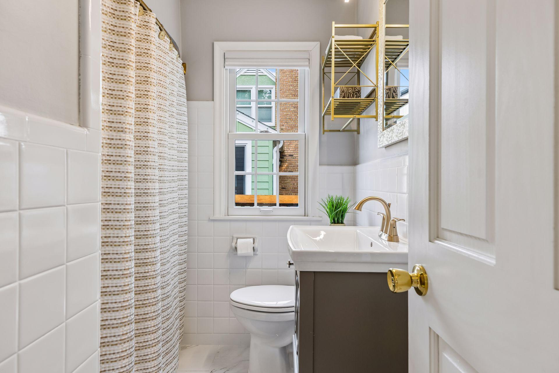 Full bath on the main level, with pull down blinds, tile floor and updated vanity.