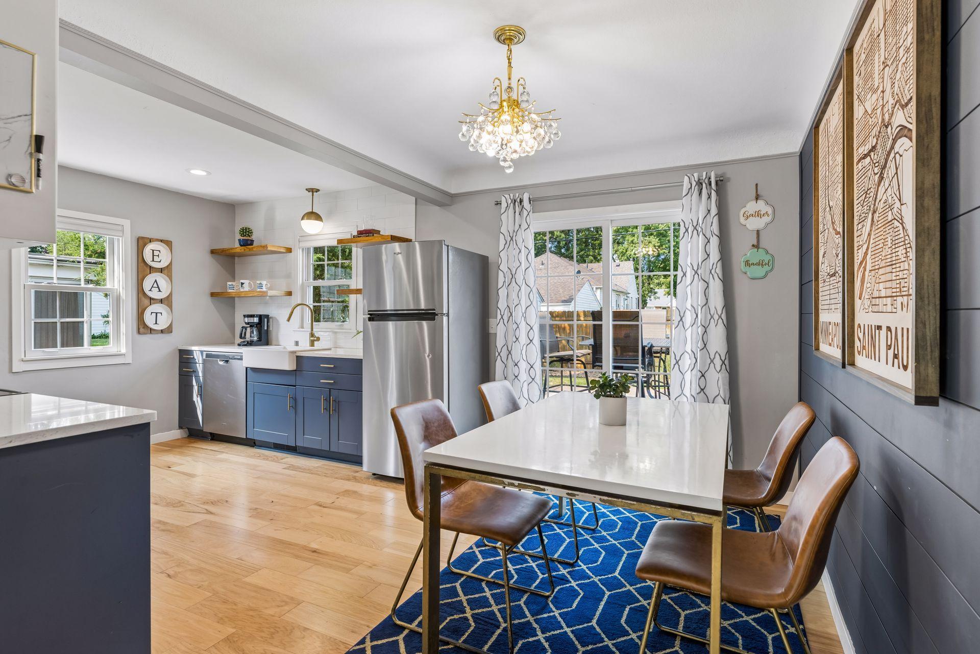 Adorable kitchen with open shelving, stainless steel appliances, and informal dining.