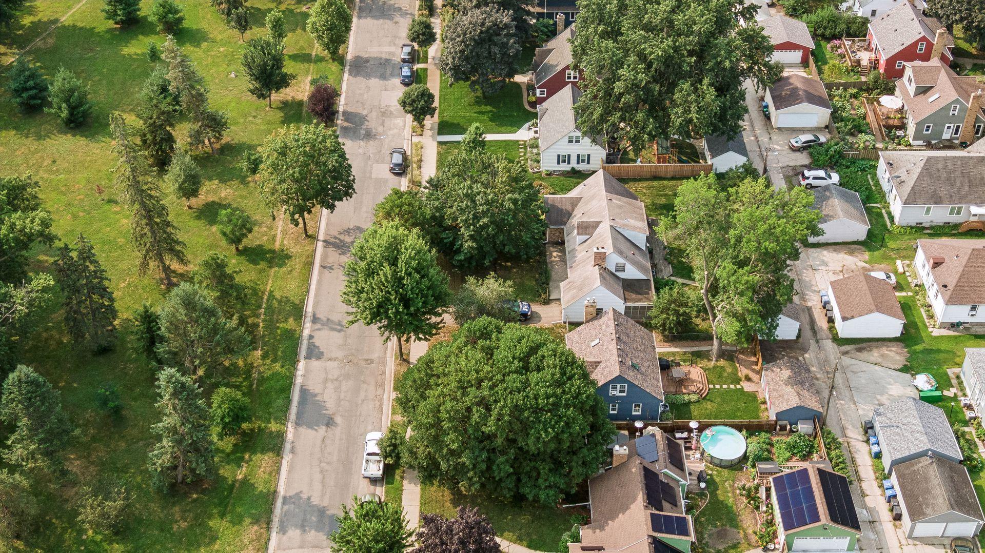 Aerial view of the fenced backyard and mature trees, and Lake Hiawatha Golf Course across the street.