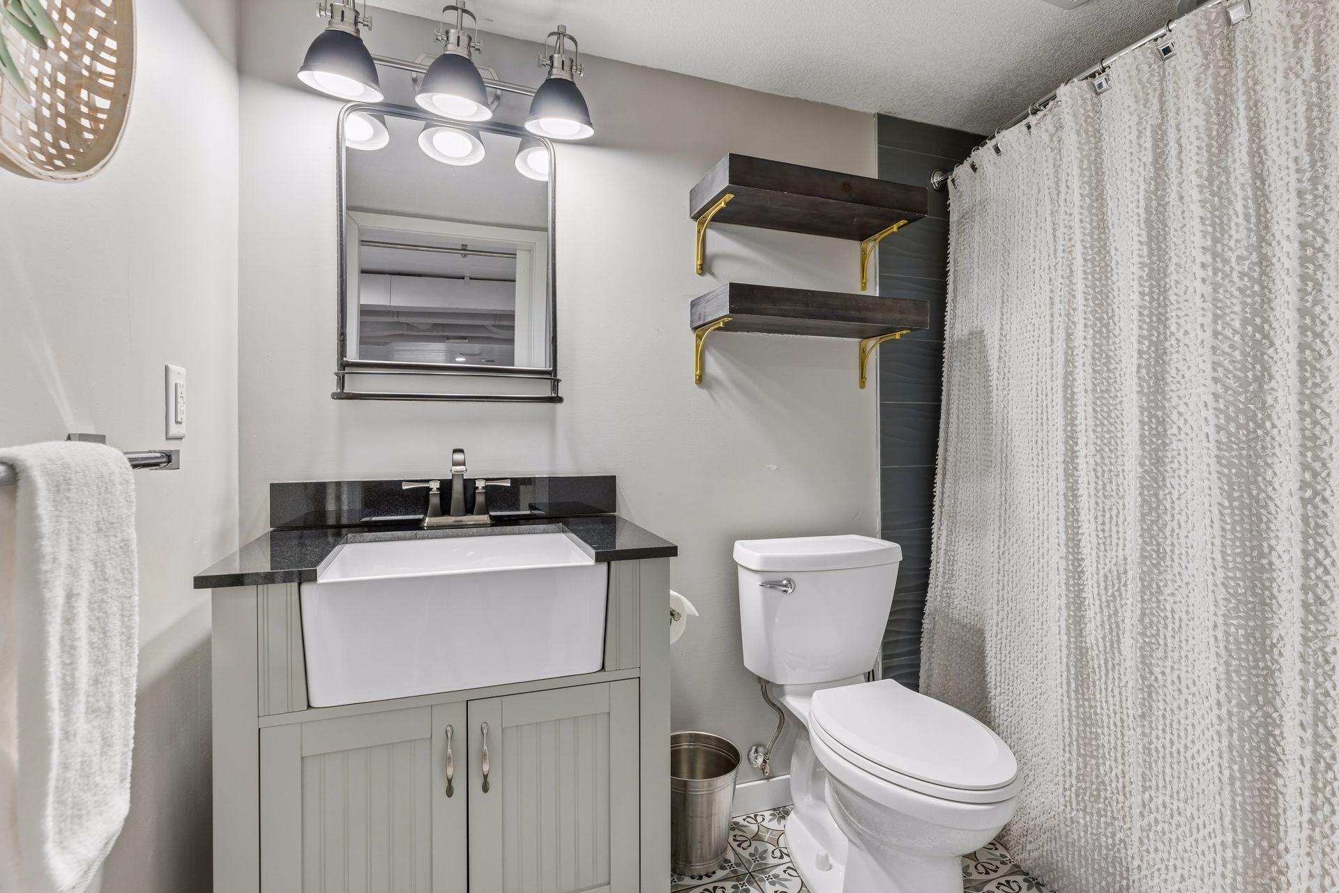 Stylish full bath on lower level, with vented fan.