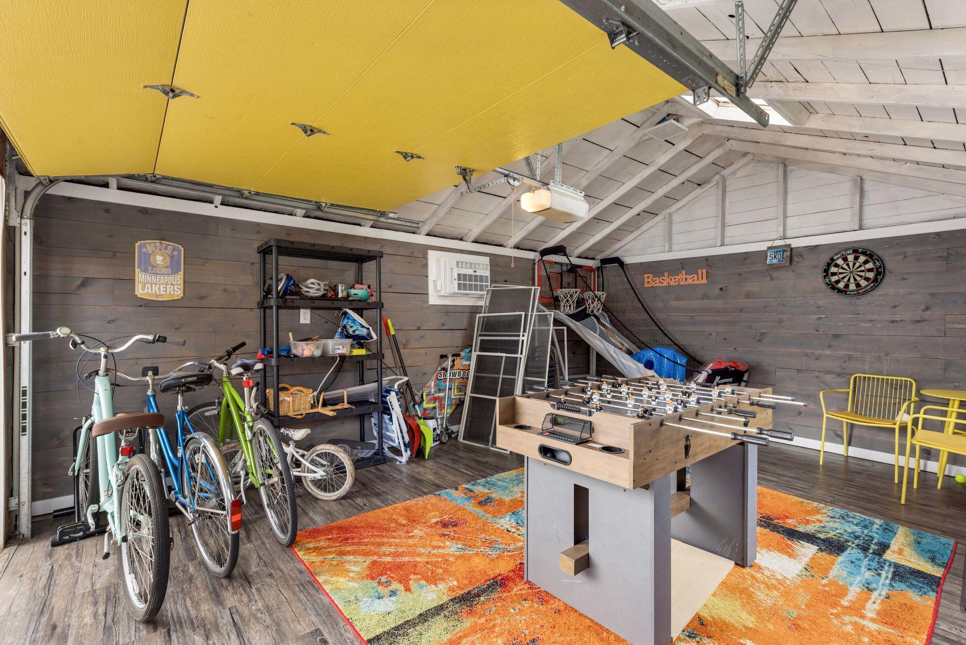 Detached one-car garage, nicely finished as a game room with skylight and a window A/C unit.