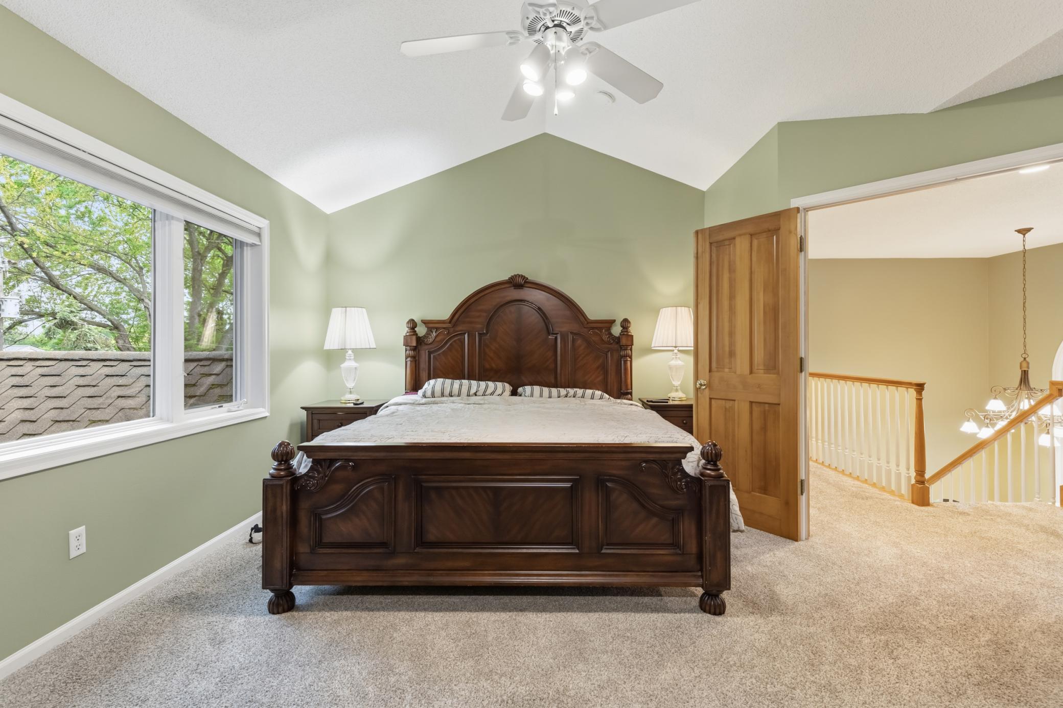 The primary bedroom in the upper level. Has solid wood double doors opening to the hallway and windows to the backyard.
