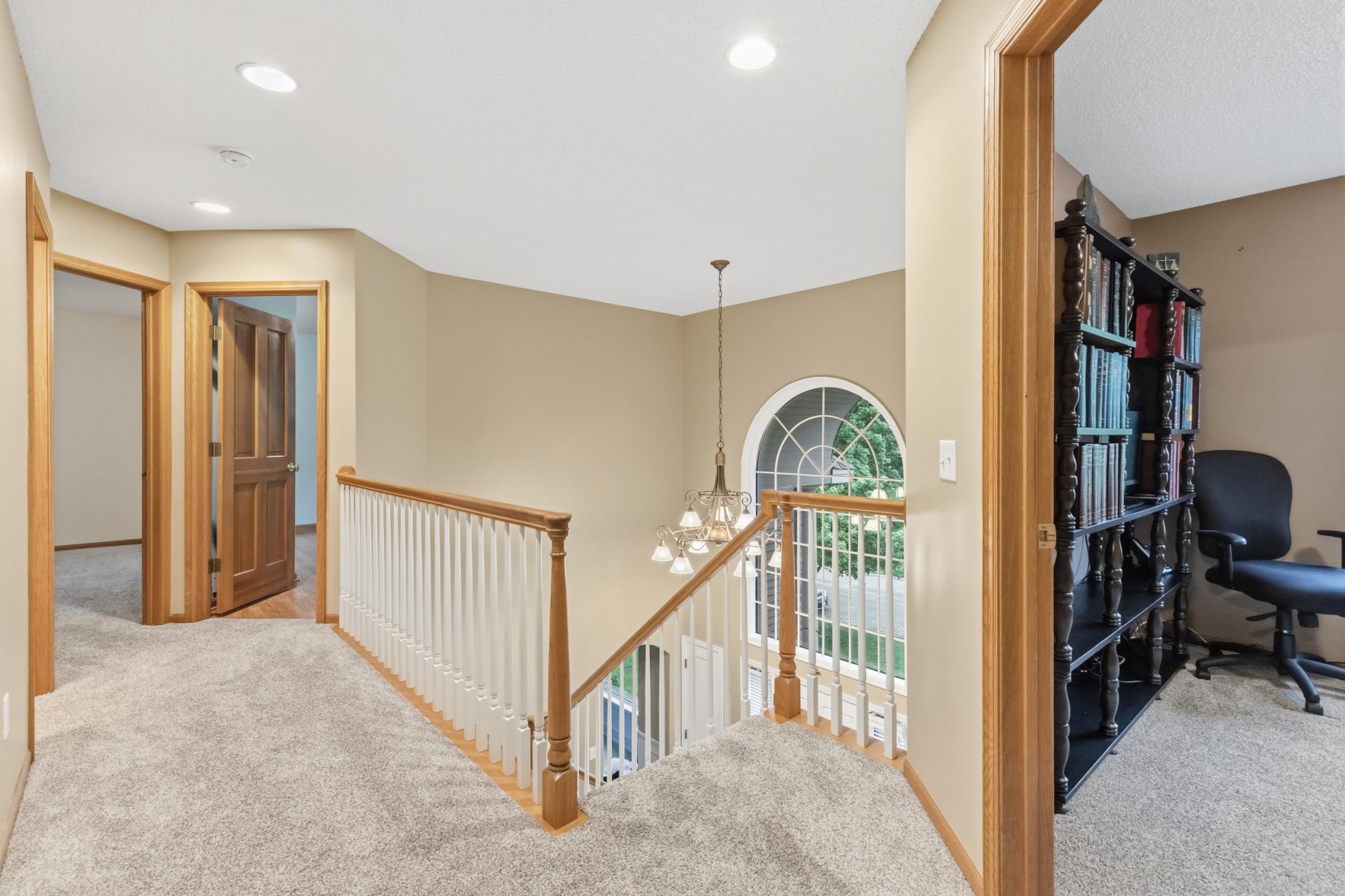 The upper level hallway overlooking the 2-story entry foyer. Very open and spacious.