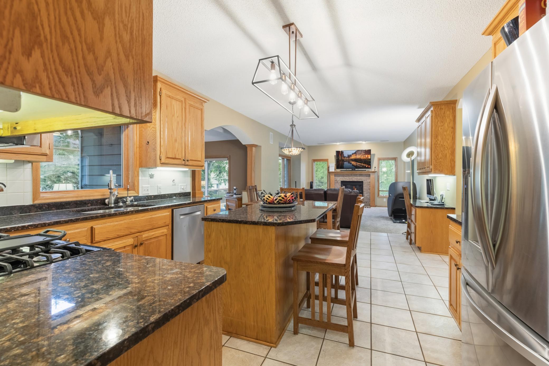 Another view of the kitchen the flows freely to the informal dining, to the family room, and to the 4-season sunroom.