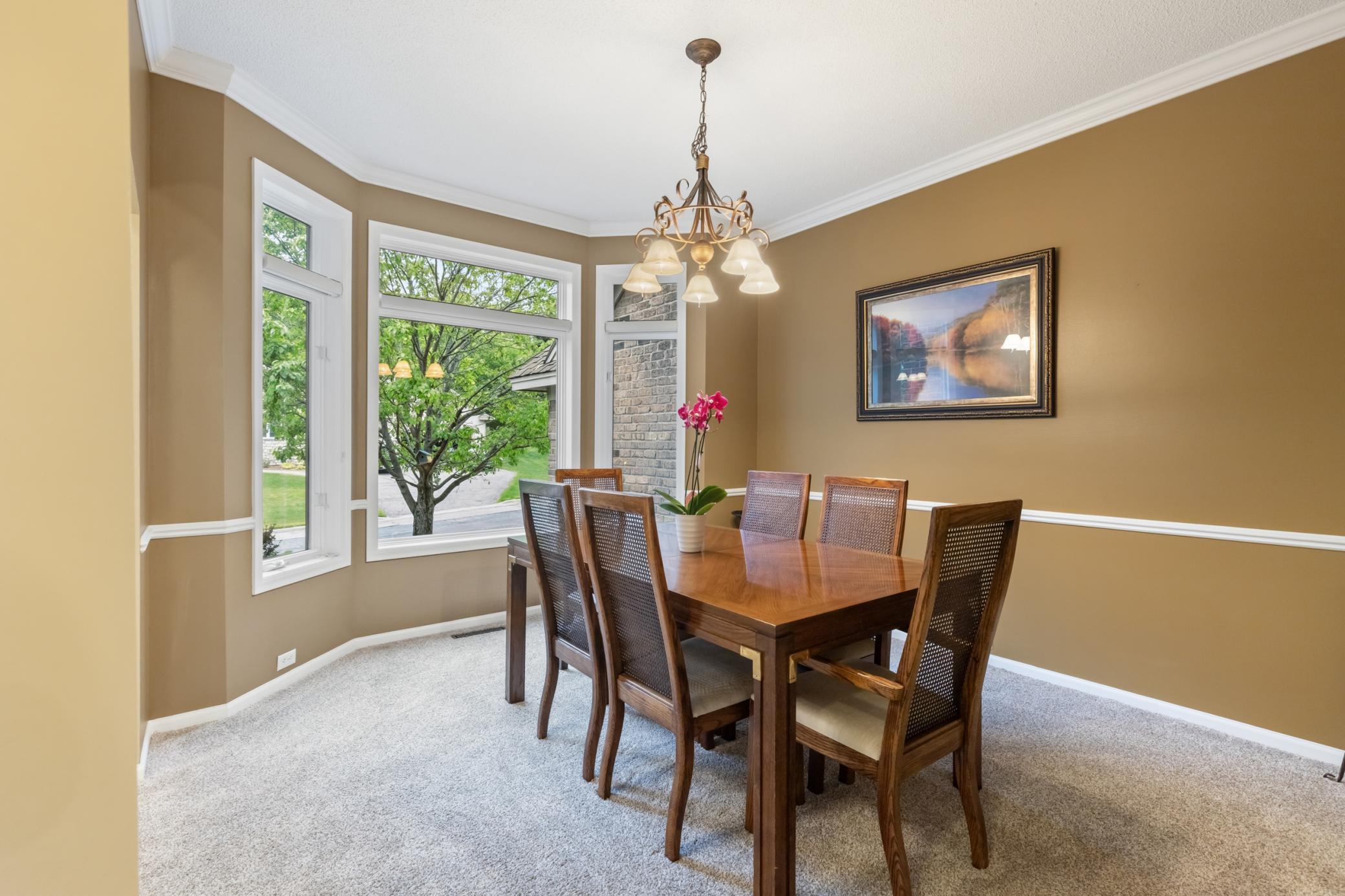Formal dining room with bay windows to allow the natural light to flood the room.
