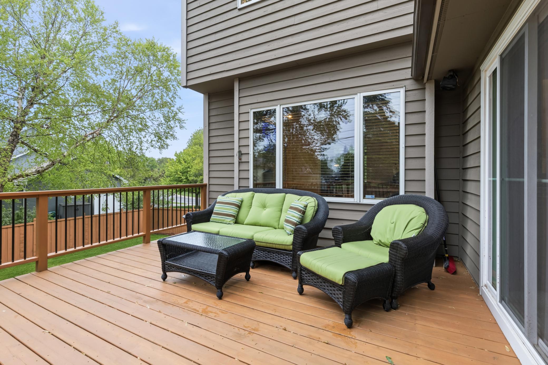The deck is conveniently located just off the four-season sunroom with stairs to get down to the backyard.