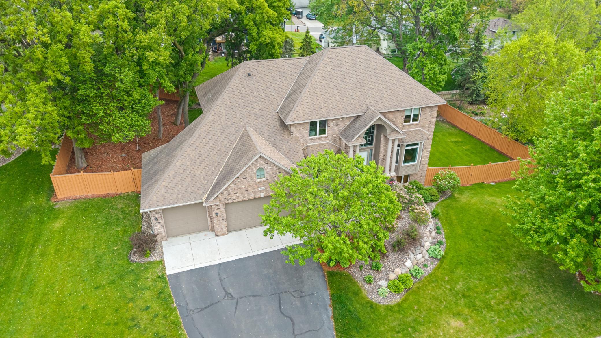 An aerial view of the fully fenced-in backyard home.