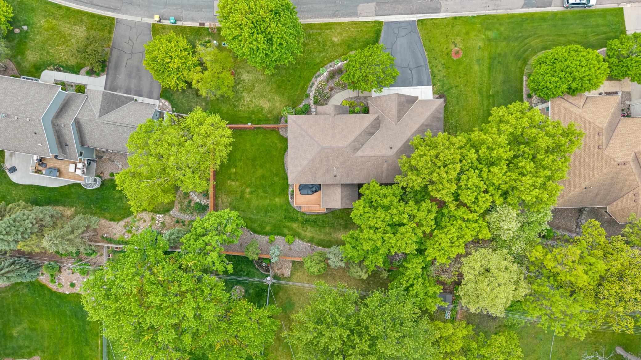 A drone shot of the property showing the matured trees along the property for added privacy.