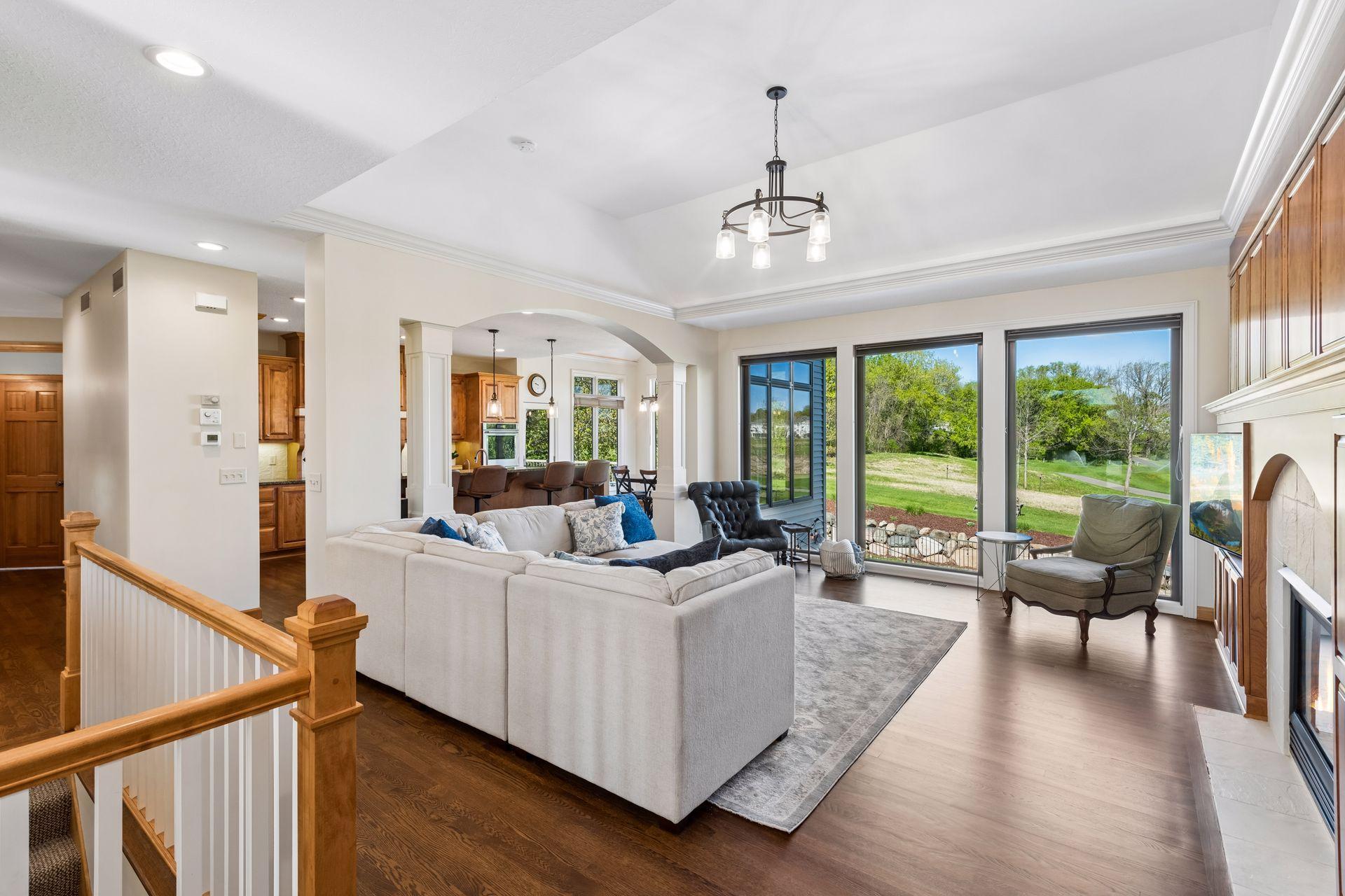Living room has gas fireplace and wonderful views of backyard, pool and golf course