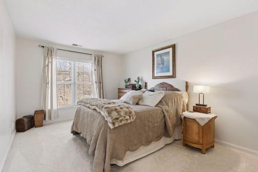 Spacious bedroom filled with natural light, featuring large windows, neutral finishes, and ample space for comfortable furnishings.