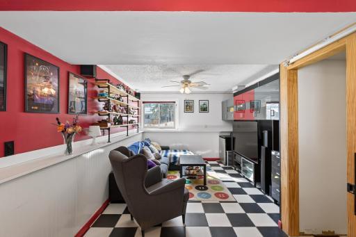 Lower level family room features built-in shelves