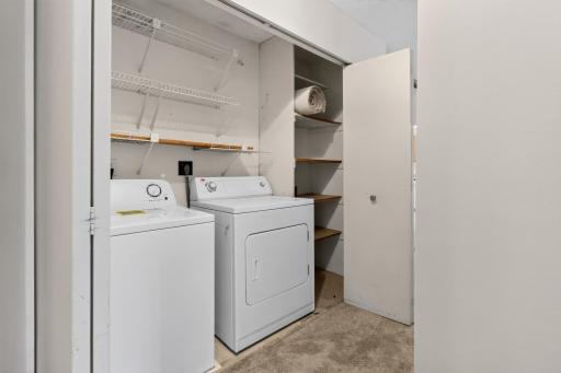 In-unit laundry closet comes complete with a full-size washer and dryer, plus built-in wire shelving for effortless organization