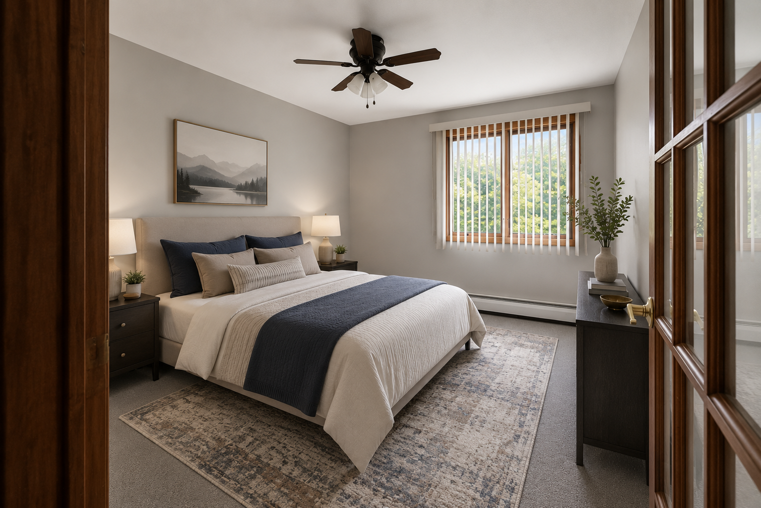 This bright bedroom showcases a comfortable layout with virtual staging, updated neutral tones, a ceiling fan, and a large picture window.