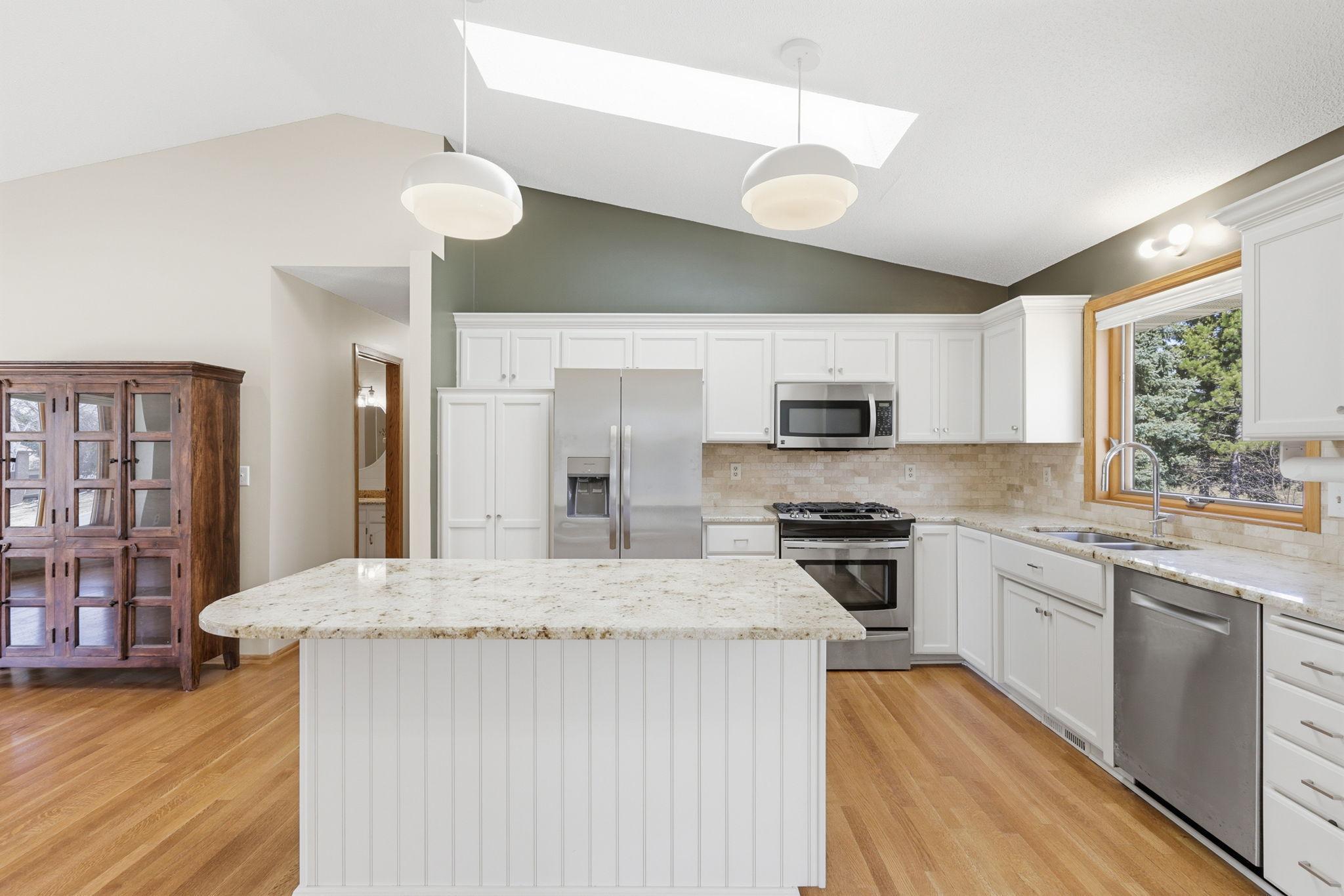 Matching stainless appliances gleam in the sunlight.