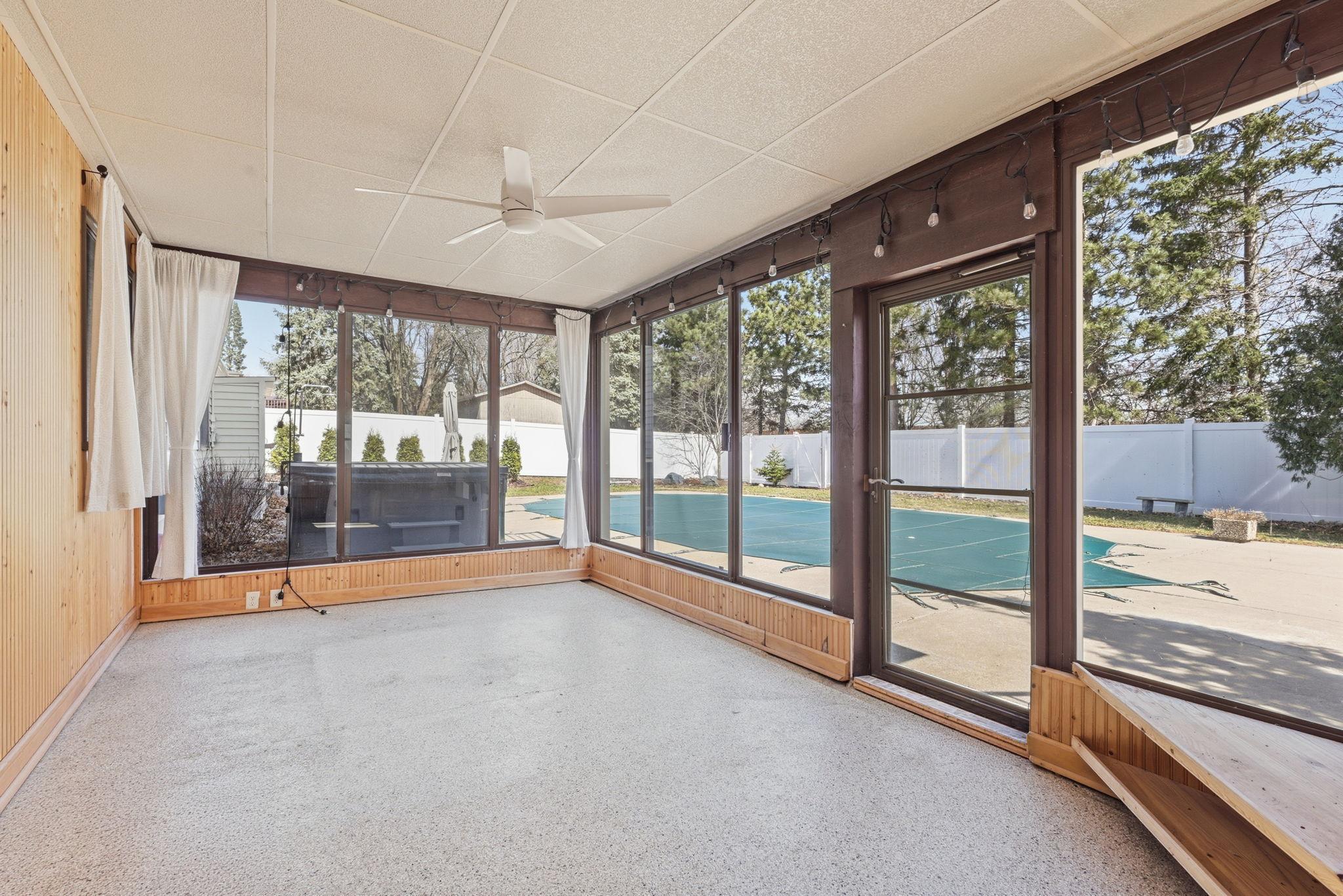 Three season porch is the perfect place to retreat from the sun after swimming!