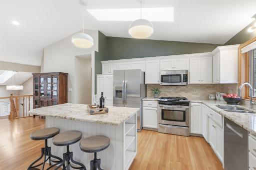 Matching stainless appliances gleam in the sunlight.