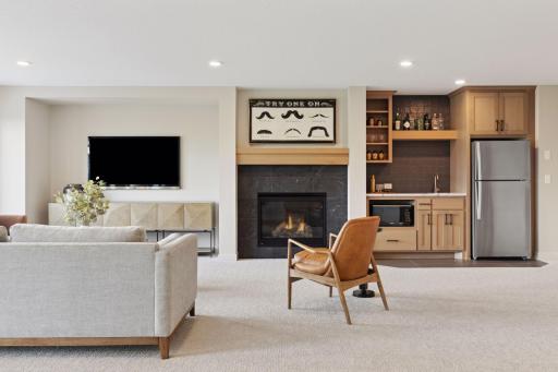 Finished lower level, gas fireplace, wet bar, athletic court