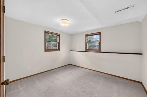 Natural light and neutral colors make this fourth lower-level bedroom bright and inviting.