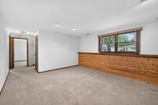Create a cozy seating or game area beside the bar in this inviting family room.