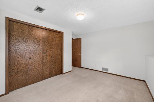 A full wall of closet doors provides excellent storage.