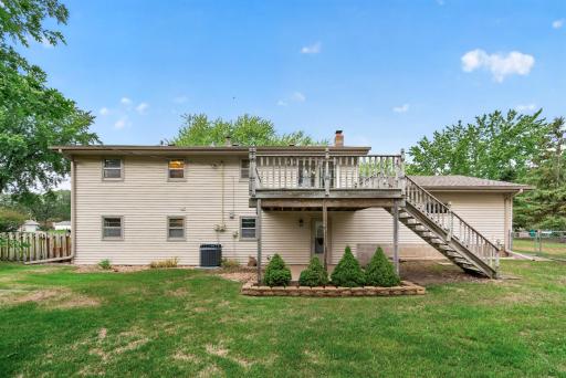 Step from the dining area onto the elevated deck, with convenient access to the yard below.