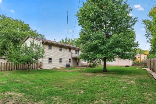 Mature trees add shade and privacy throughout.