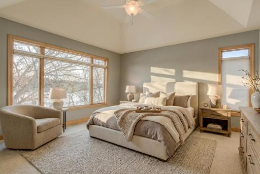 The main level offers a spacious ownerâs suite complete with a walk-in shower and jetted tub, creating a private retreat to recharge. (virtually staged)